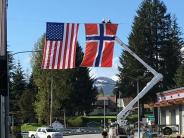 'Flag Raisings' - May Festival & 4th of July, and seasonal banners on Nordic Drive, are traditionally put up for display by the linemen. American and Norwegian flags over Main Street