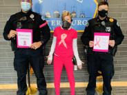 Officer Tate, Dispatcher Canton, and Captain Holmgrain wear pink in support of Breast Cancer Awareness. 